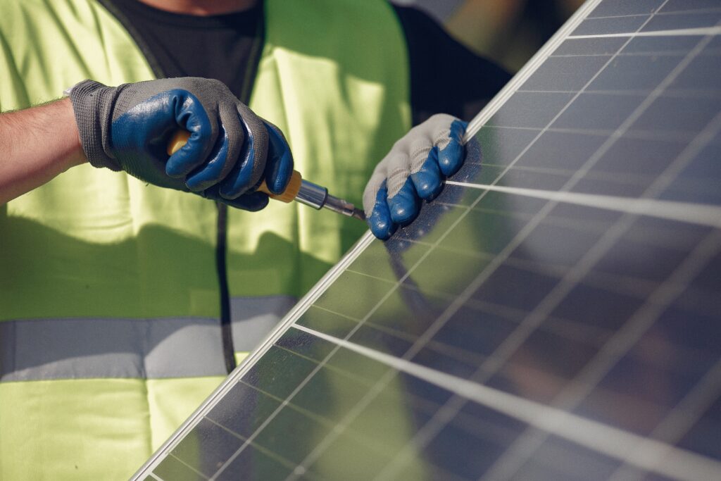 Technician installing rooftop solar panels with support from solar companies in Ernakulam