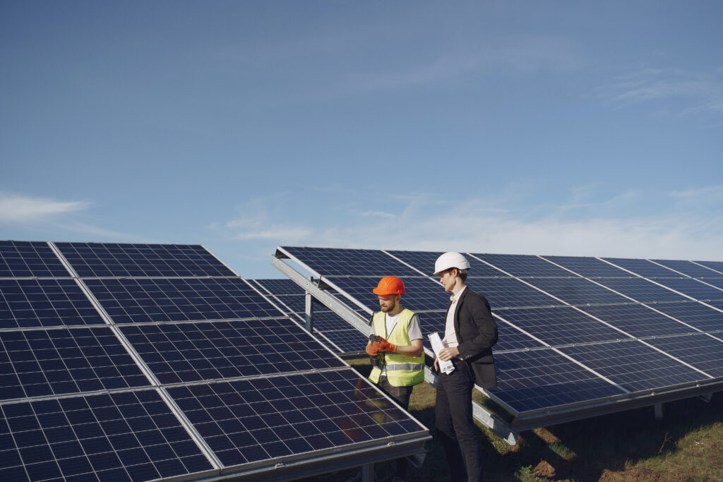 Technicians inspecting and installing rooftop solar panels at a residential site in Kerala, representing professional services by solar companies in Kerala.