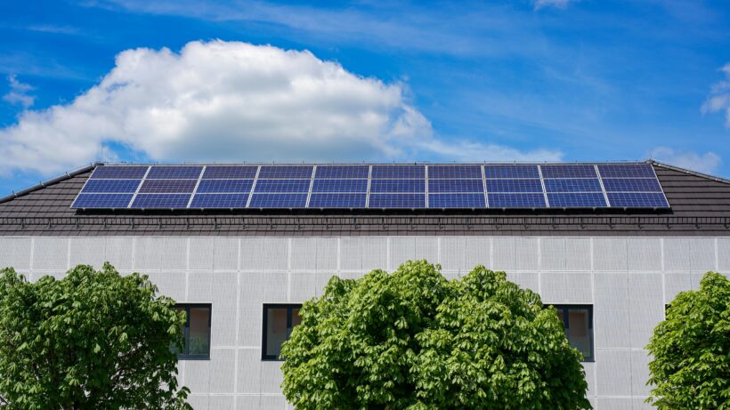 Rooftop solar panel installation on a modern building by solar power companies in Kerala, generating clean and sustainable energy